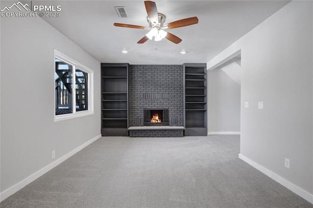 unfurnished living room featuring ceiling fan, carpet, and a fireplace