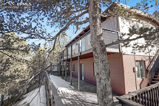 view of side of home with a wooden deck