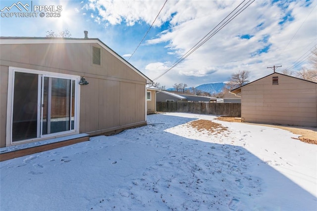 yard covered in snow with a mountain view