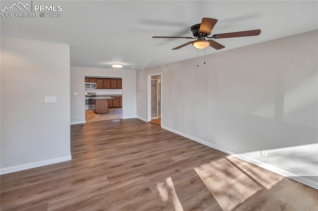 empty room featuring hardwood / wood-style floors and ceiling fan