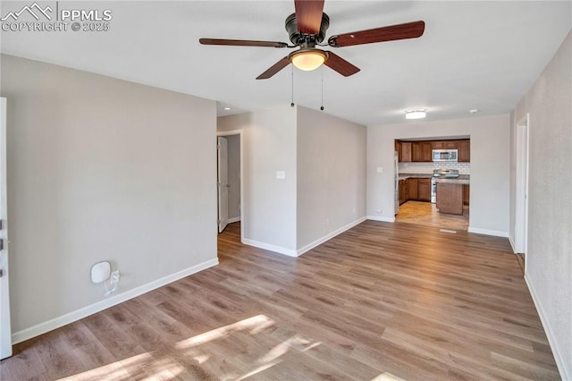 unfurnished living room featuring ceiling fan and light wood-type flooring