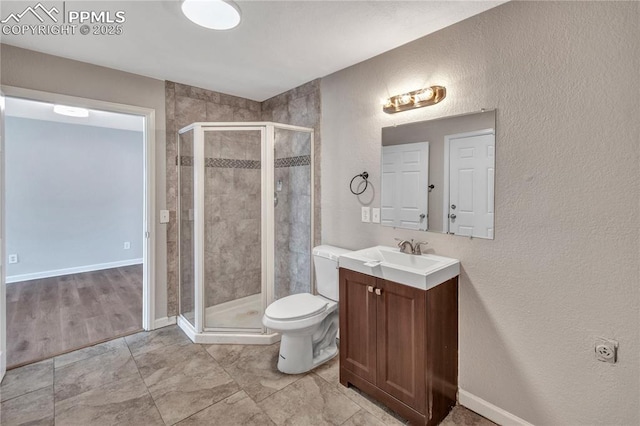 bathroom with vanity, walk in shower, and toilet