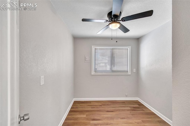 spare room with light hardwood / wood-style floors, ceiling fan, and a textured ceiling