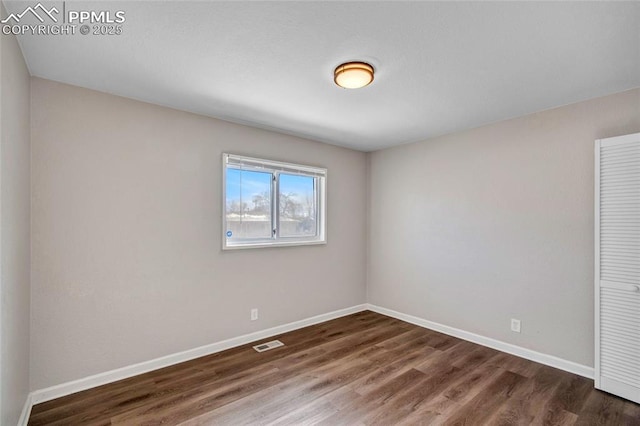 unfurnished room featuring dark hardwood / wood-style floors