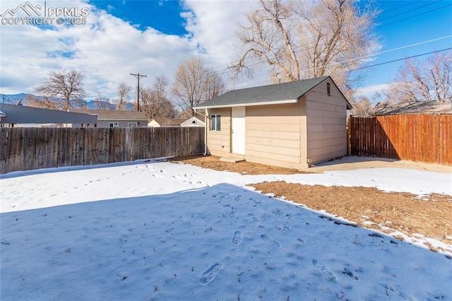 snowy yard with an outdoor structure