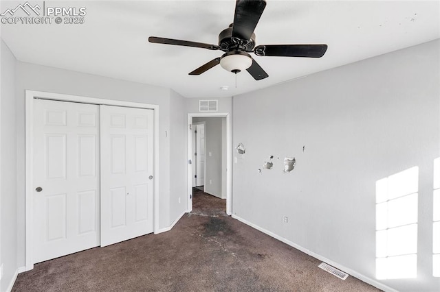 unfurnished bedroom featuring ceiling fan, a closet, and dark carpet