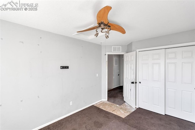 unfurnished bedroom with a closet, dark carpet, and ceiling fan