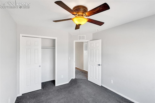 unfurnished bedroom featuring ceiling fan, dark carpet, and a closet