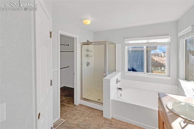 bathroom featuring vanity, tile patterned floors, and independent shower and bath