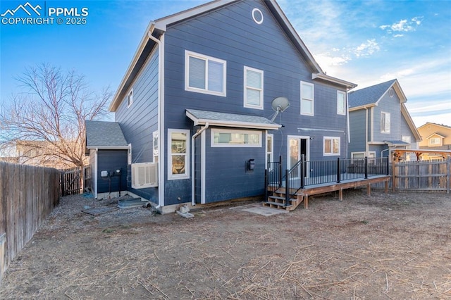 rear view of house featuring a wooden deck