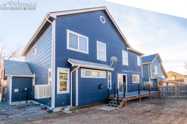 rear view of property featuring cooling unit and a deck