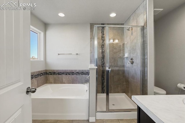 full bathroom featuring tile patterned floors, vanity, independent shower and bath, and toilet