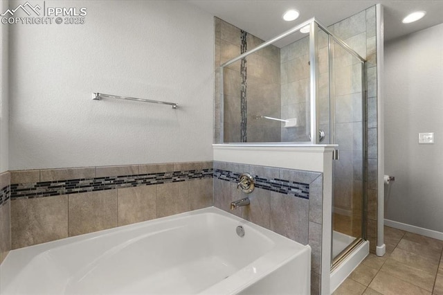 bathroom featuring tile patterned flooring and shower with separate bathtub