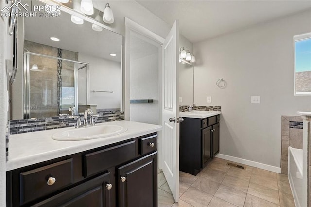 bathroom featuring tile patterned floors, vanity, and shower with separate bathtub