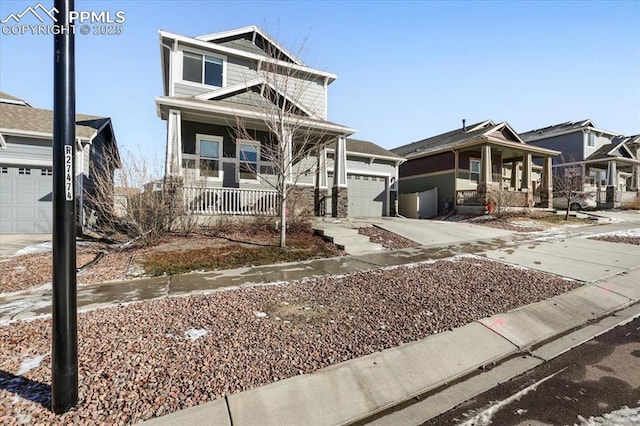 view of front of property featuring covered porch and a garage