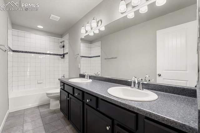 full bathroom with tile patterned floors, vanity, toilet, and tiled shower / bath