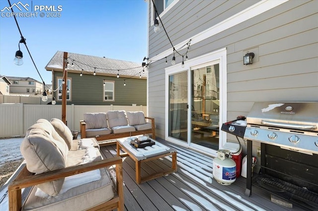 wooden deck featuring area for grilling and an outdoor living space