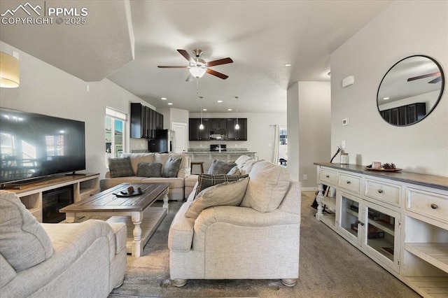 carpeted living room with ceiling fan