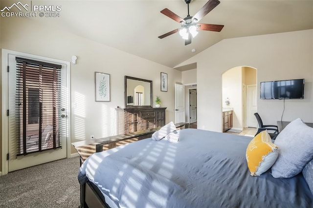 carpeted bedroom with ceiling fan, ensuite bathroom, and vaulted ceiling