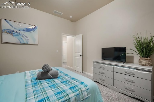 bedroom featuring light carpet