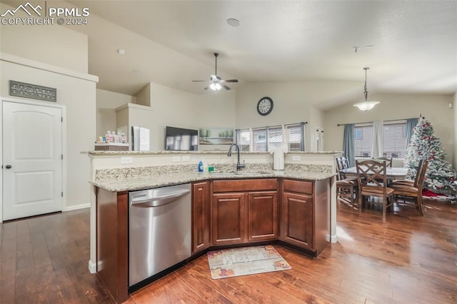 kitchen featuring a kitchen island with sink, pendant lighting, stainless steel dishwasher, and vaulted ceiling