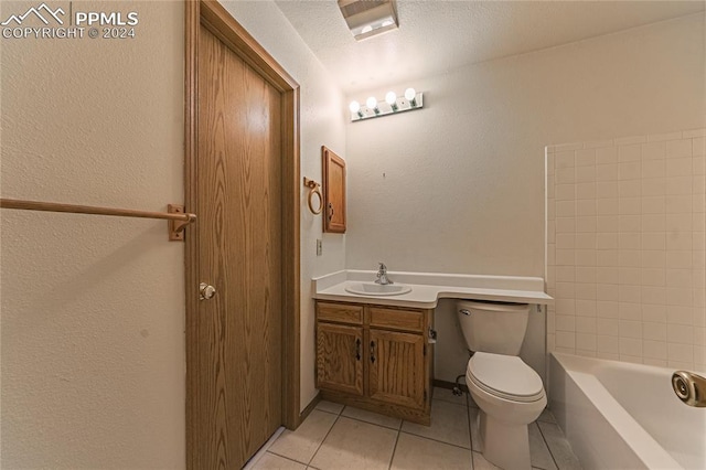 bathroom featuring tile patterned flooring, a textured ceiling, vanity, and toilet