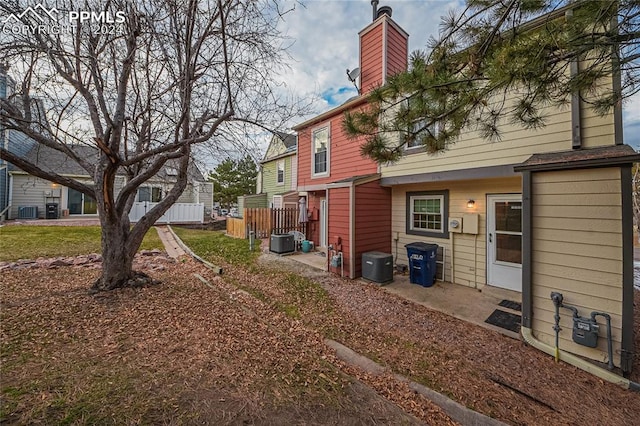 view of yard with central AC and a patio