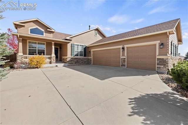 craftsman-style home with a porch and a garage