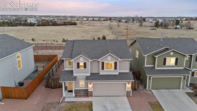 view of front of property with a garage and central air condition unit