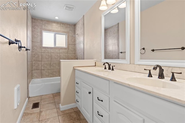 bathroom with vanity, tile patterned floors, and tiled shower / bath