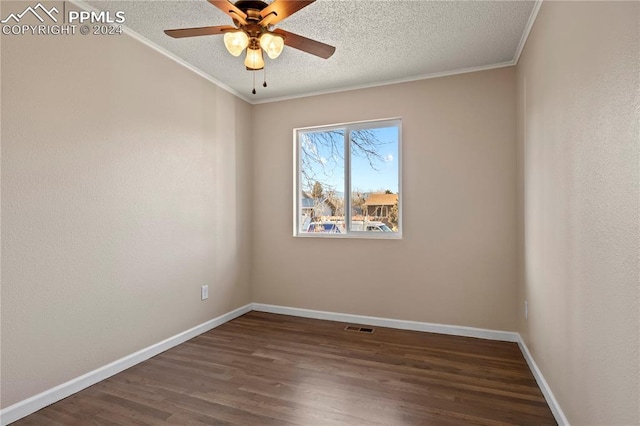 empty room with a textured ceiling, dark hardwood / wood-style flooring, ceiling fan, and crown molding