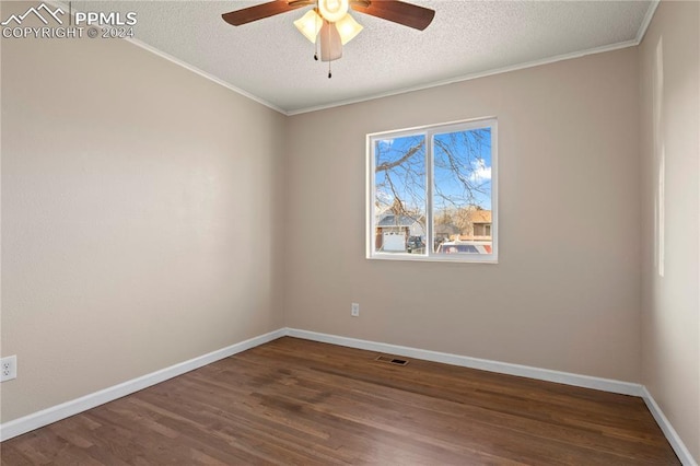 unfurnished room featuring visible vents, crown molding, baseboards, wood finished floors, and a textured ceiling