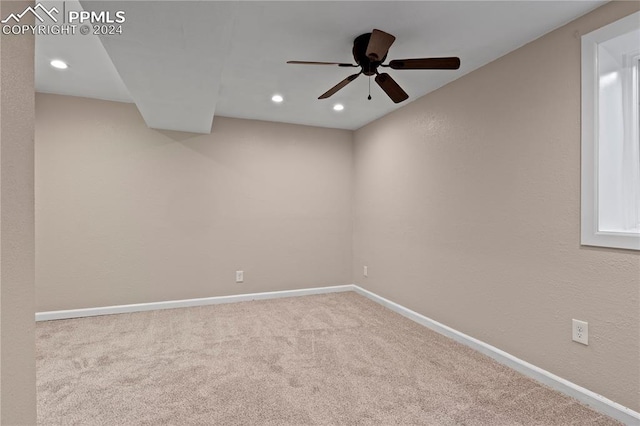 carpeted spare room featuring recessed lighting, a ceiling fan, and baseboards