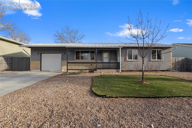 ranch-style home with a porch, a garage, and a front lawn