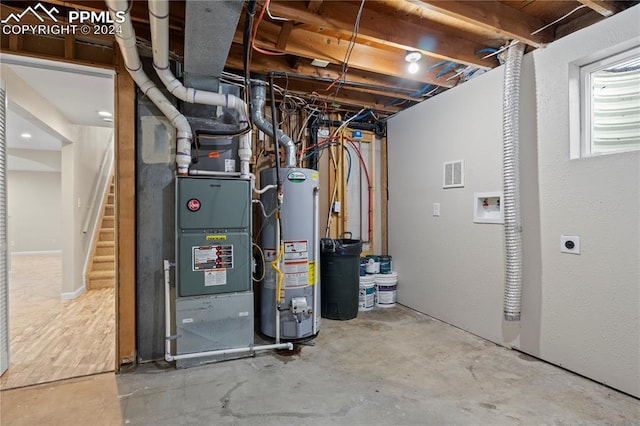 utility room with visible vents and gas water heater