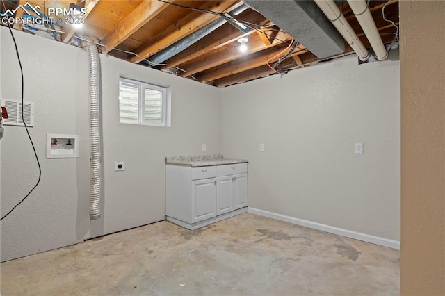 basement featuring visible vents and baseboards