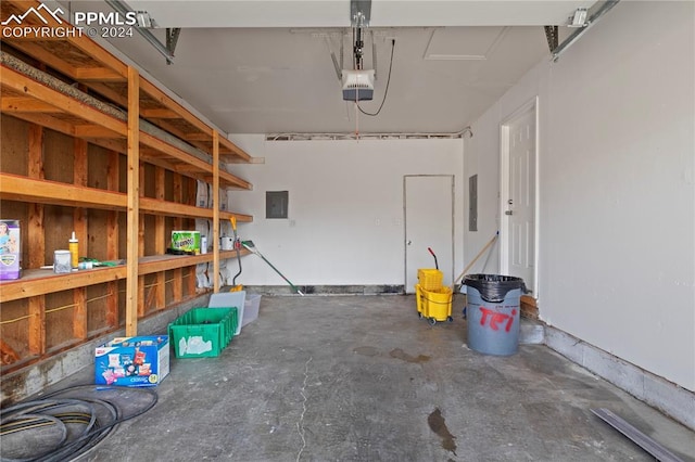 garage with electric panel and a garage door opener