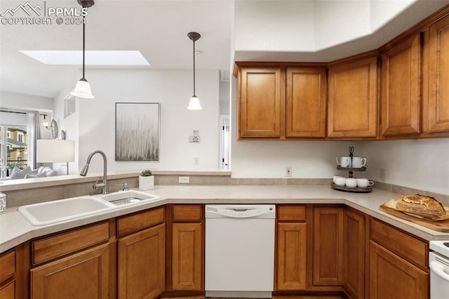 kitchen with a skylight, sink, white dishwasher, and hanging light fixtures