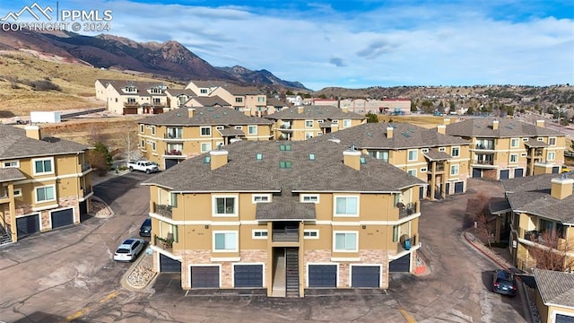 birds eye view of property with a mountain view