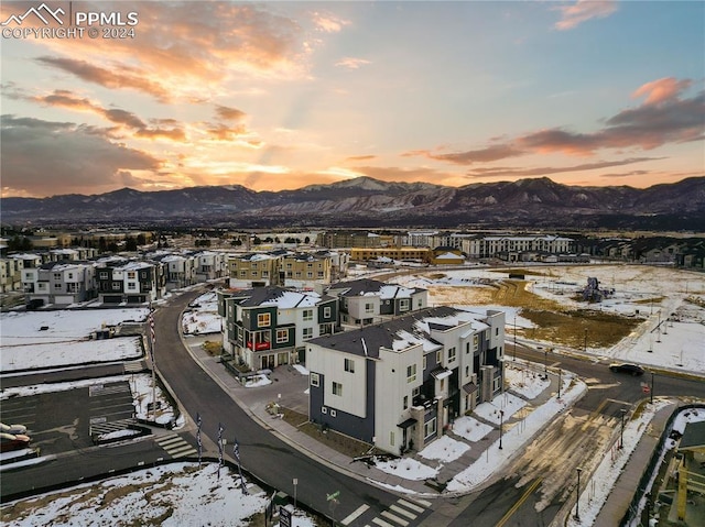 snowy aerial view with a mountain view