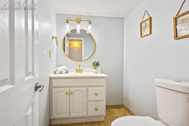 bathroom featuring tile patterned floors, vanity, and toilet