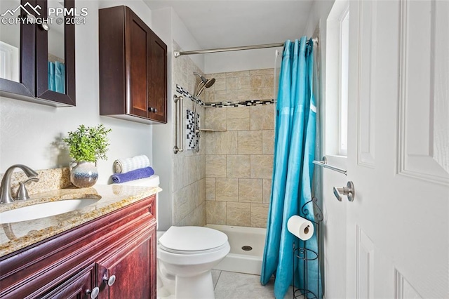 bathroom with tile patterned floors, a shower with curtain, toilet, and vanity