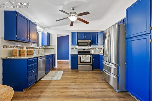 kitchen featuring sink, blue cabinets, and stainless steel appliances