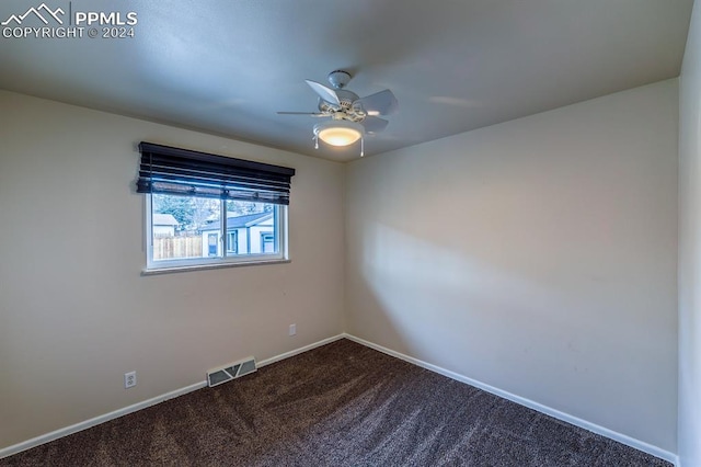 carpeted spare room with ceiling fan