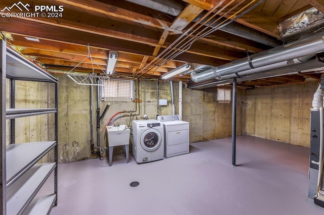 basement featuring sink and washing machine and clothes dryer