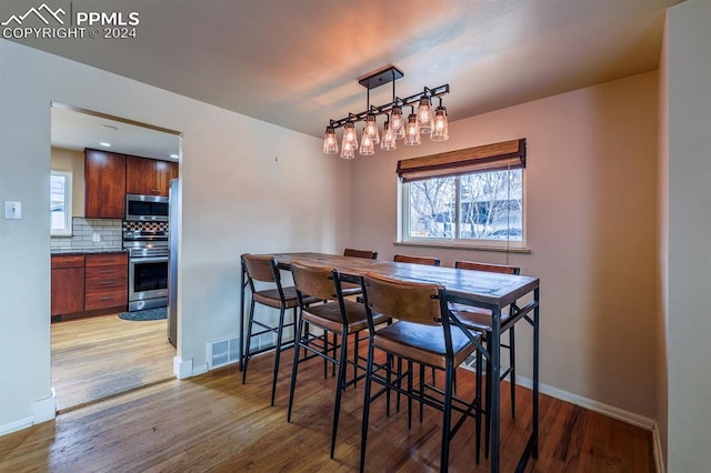 dining space with light wood-type flooring