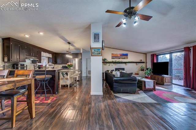 living room featuring dark hardwood / wood-style flooring, ornamental molding, a textured ceiling, vaulted ceiling, and ceiling fan