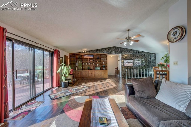 living room featuring hardwood / wood-style floors, ceiling fan, a textured ceiling, and vaulted ceiling