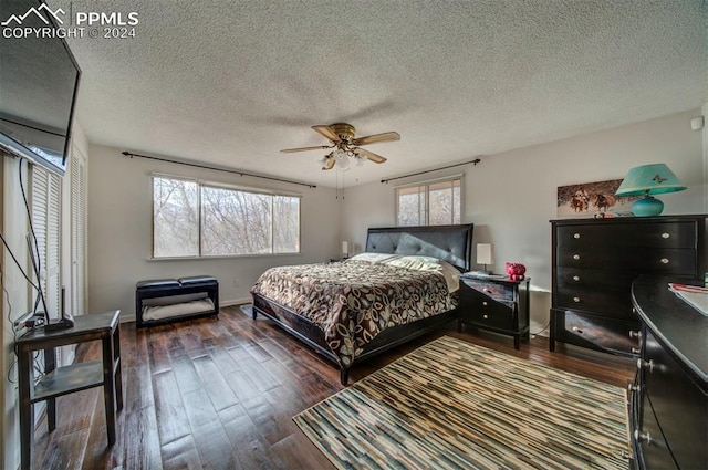 bedroom featuring ceiling fan, a textured ceiling, and dark wood-type flooring