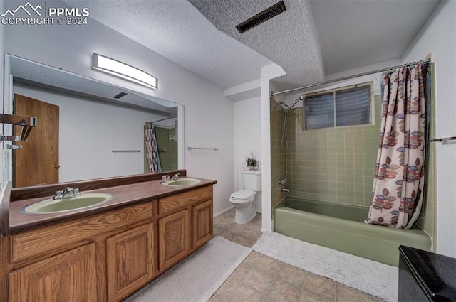 full bathroom featuring vanity, shower / tub combo, a textured ceiling, and toilet